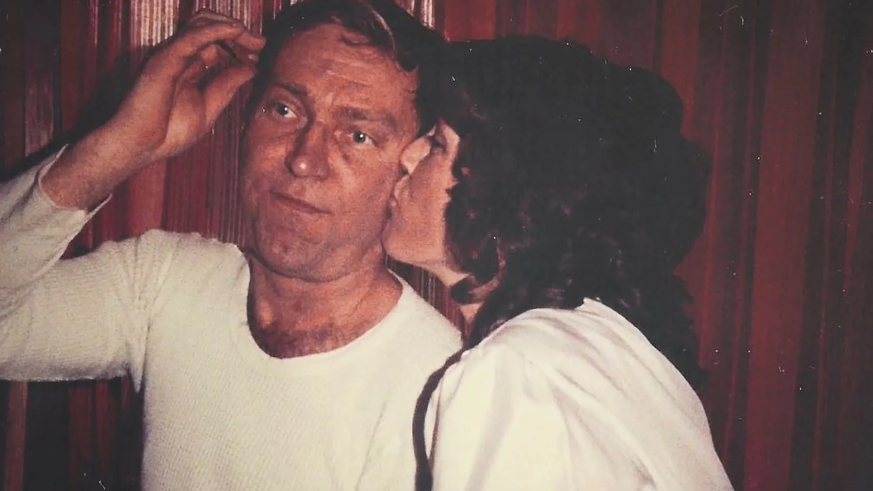 An older photograph shows an adult holding a young child.