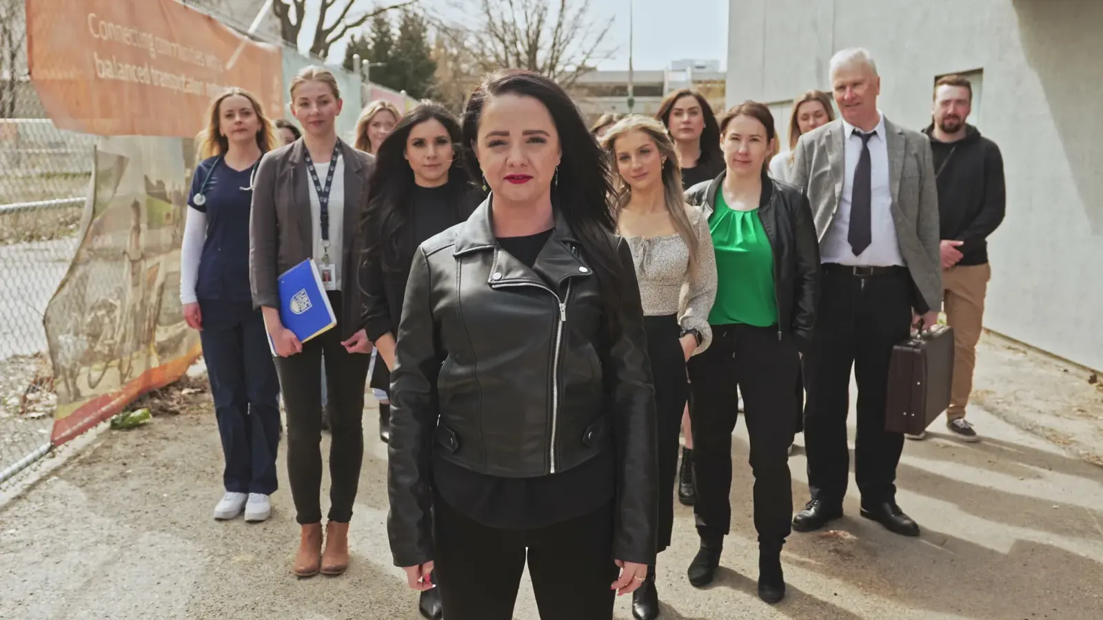 Amanda McFarlane and a support-network cast walk toward camera in the BrainTrust Canada one-take awareness film.
