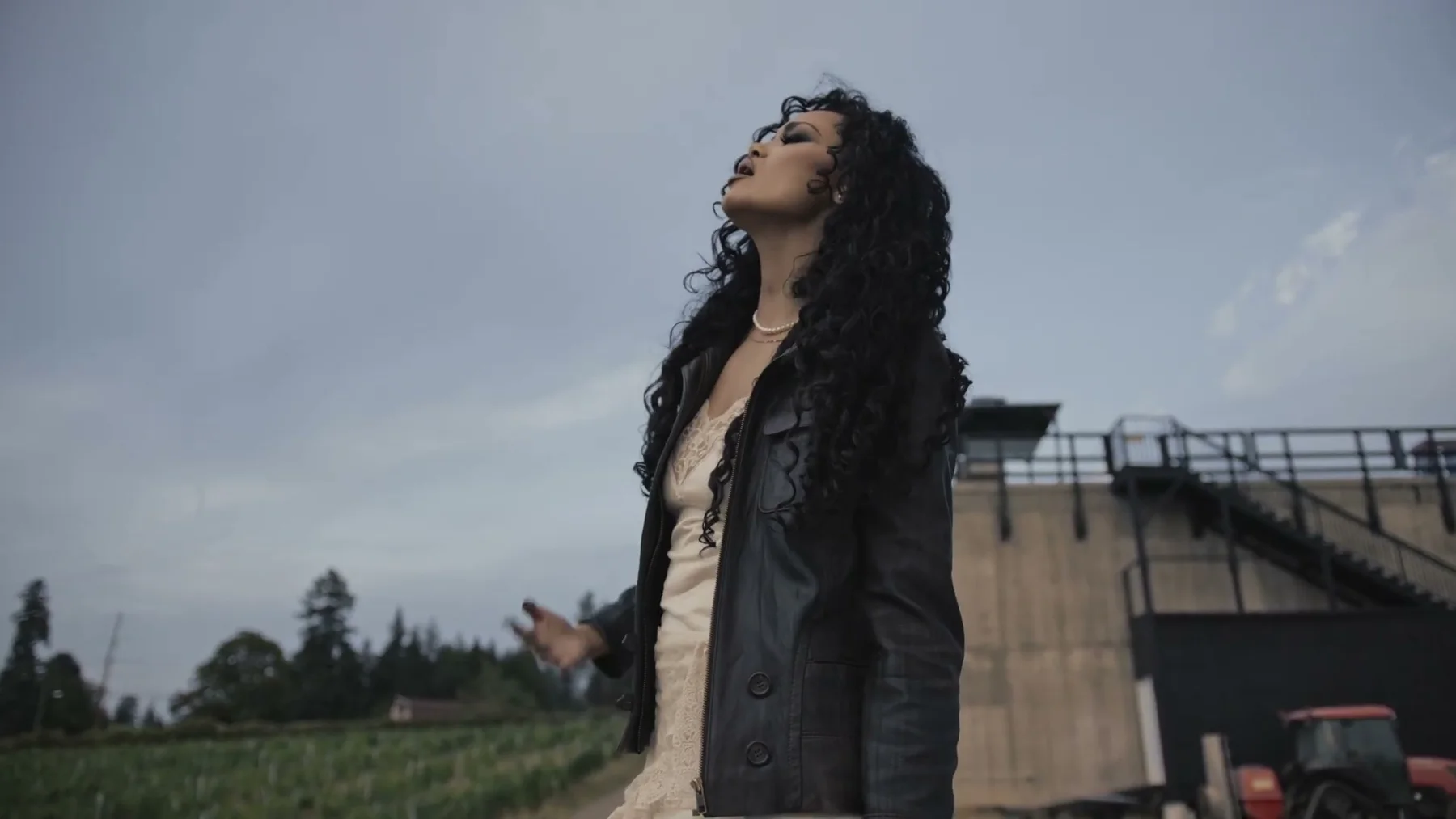 Alexandra Wright performs outdoors in a white dress and black jacket in Colorado.