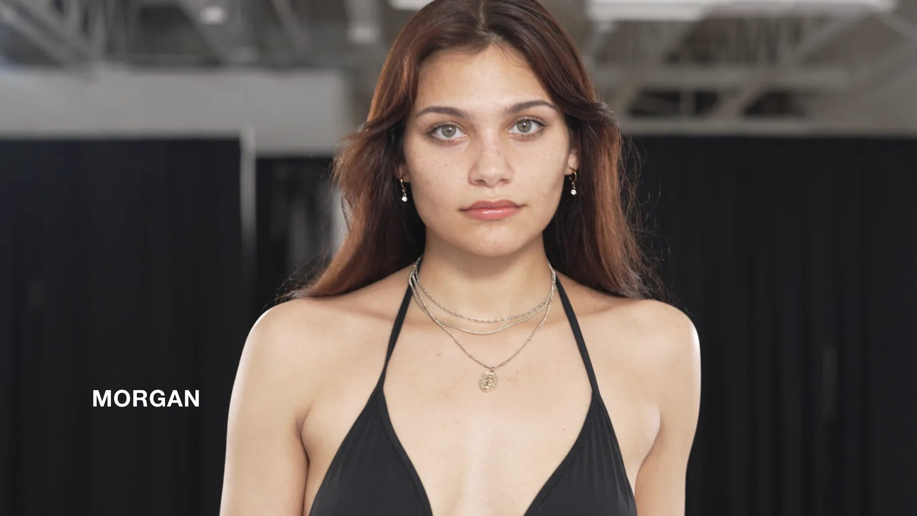 Morgan in swimwear with her name on screen during the Deja Vu Model Search.