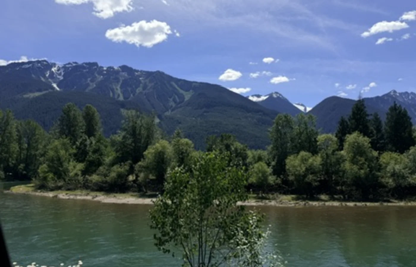 River and mountain field photograph from Displaced.
