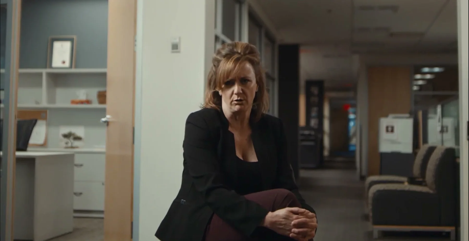 Ginny Becker speaks from a hallway between child-support rooms.