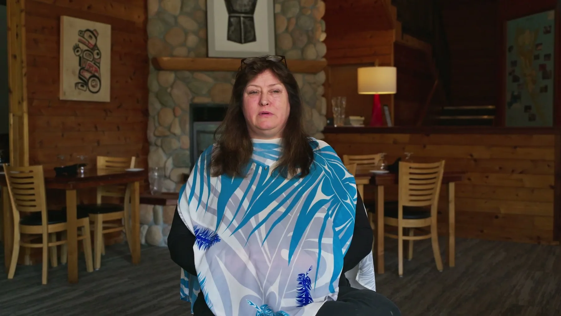 A woman speaks inside the Haida House lodge.