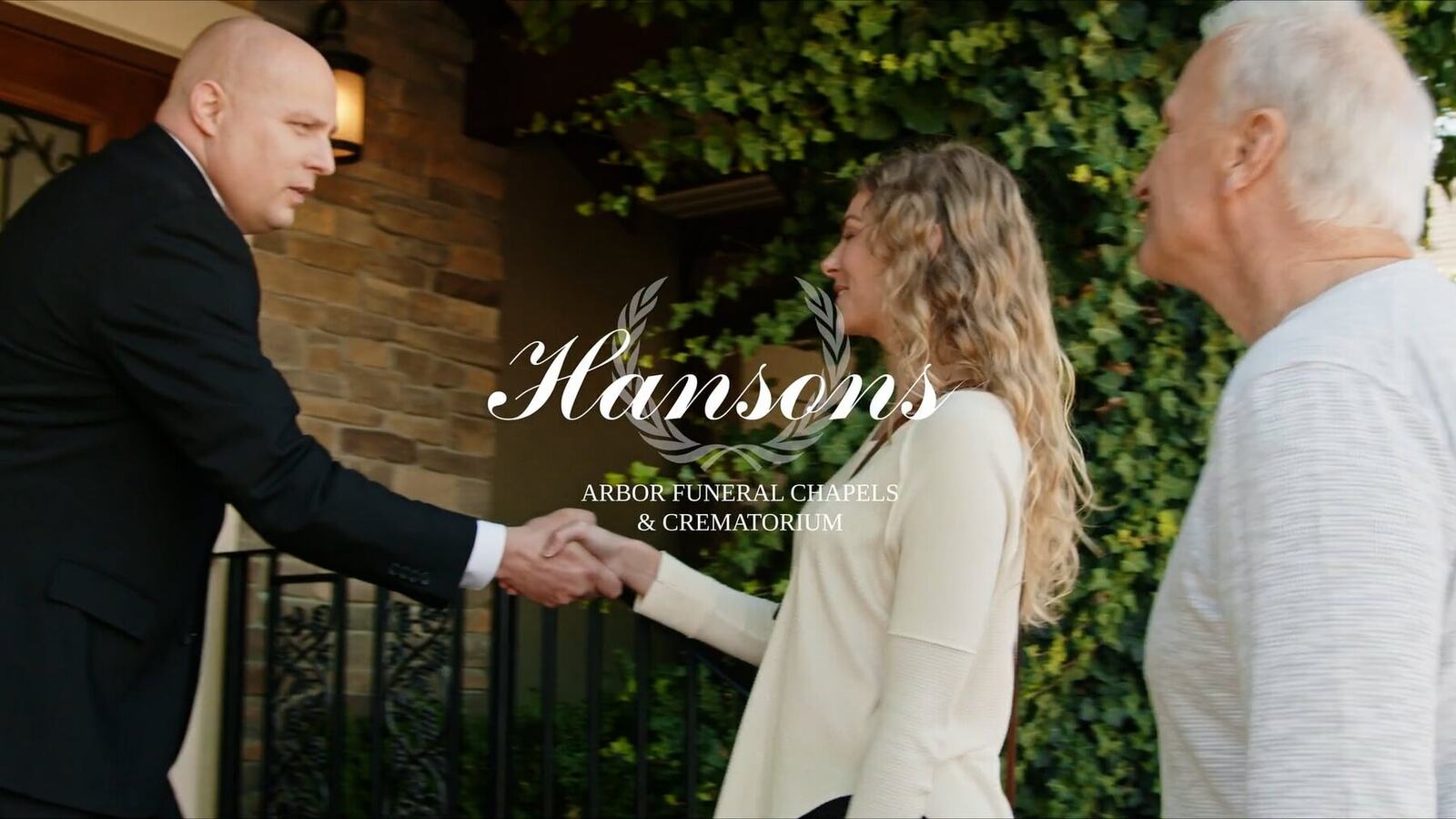 A Hanson’s Arbor representative welcomes a family outside the funeral chapel.