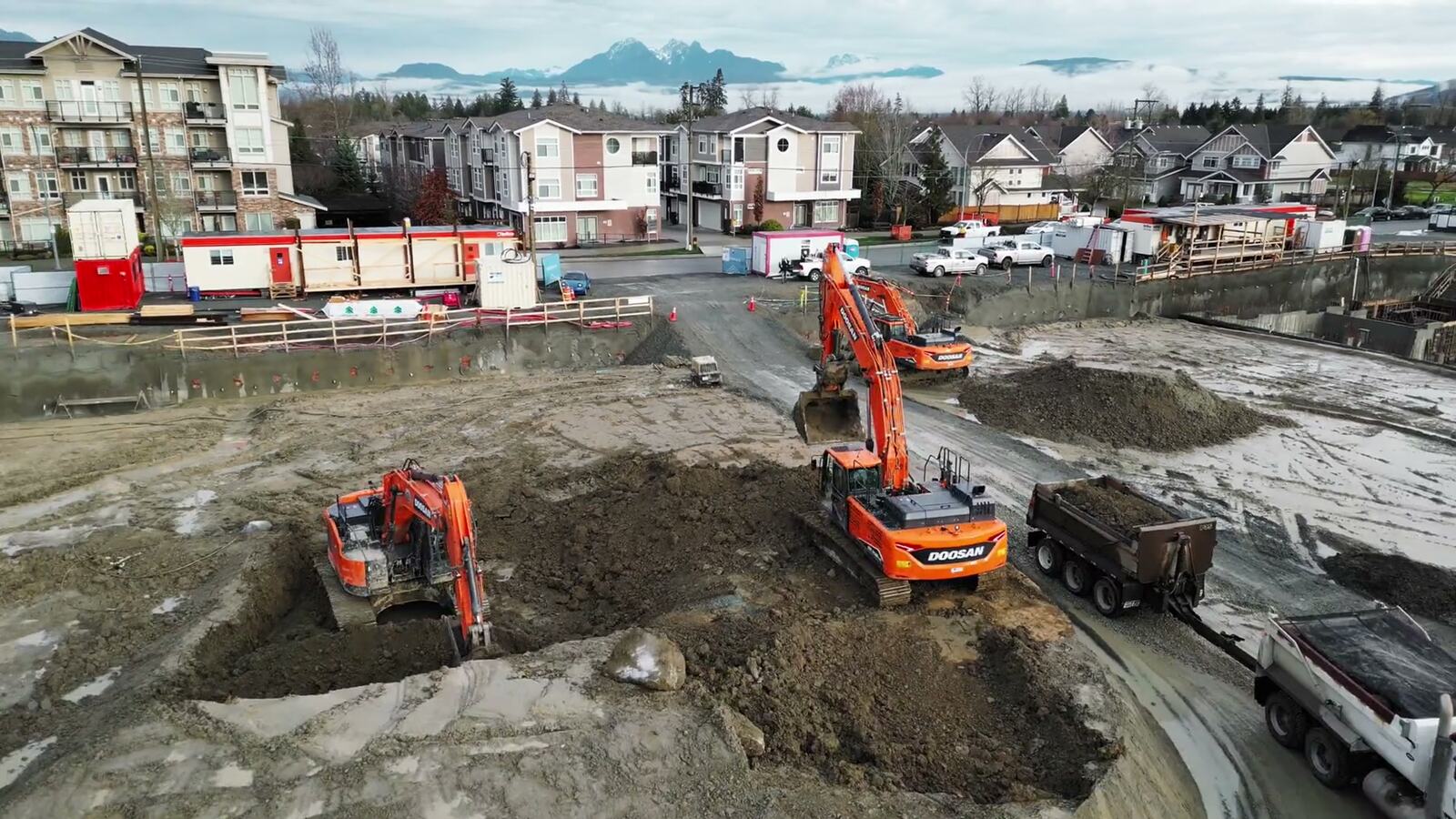 Drone frame of excavators, trucks and a foundation excavation site for High Road Excavating.