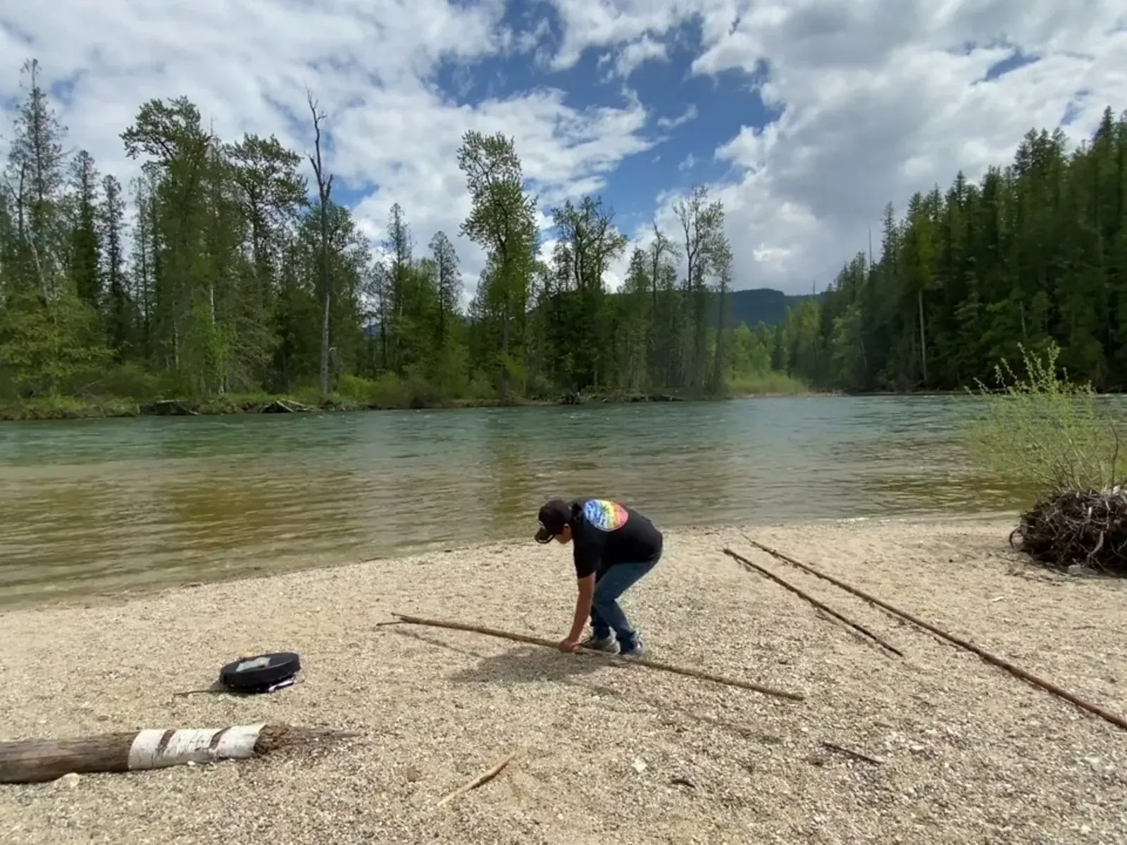 Laureen Felix demonstrating traditional fishing practices on the riverbank.