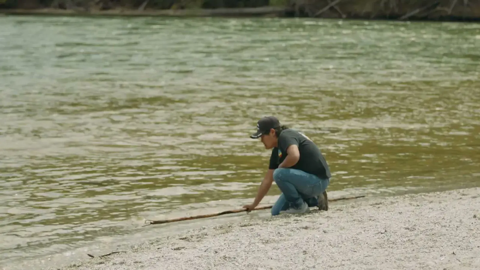 Laureen Felix demonstrating Splatsin traditional fishing practices beside the Lower Shuswap River.