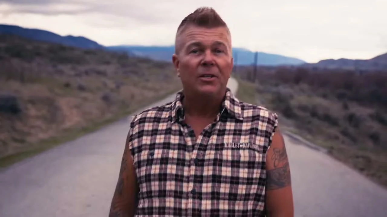 Trevor Ingram stands in the middle of a rural road.