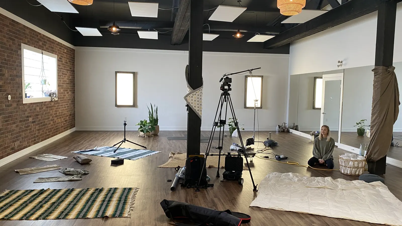 Camera, tripod, lav and production setup inside Our Yoga Space during the COVID-era class-library shoot.