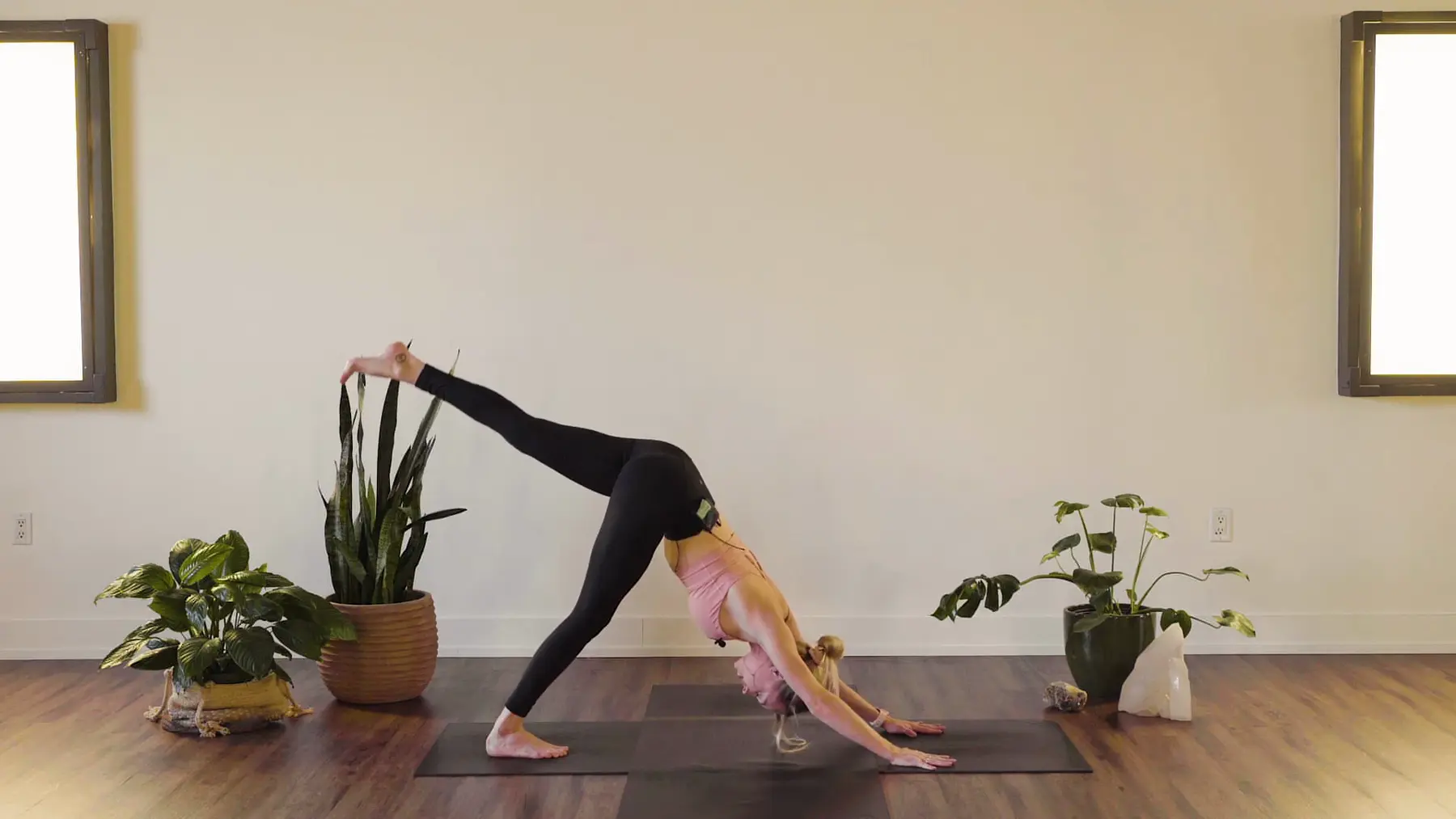 Taylor Morrice in a three-legged downward dog during an Our Yoga Space online class.