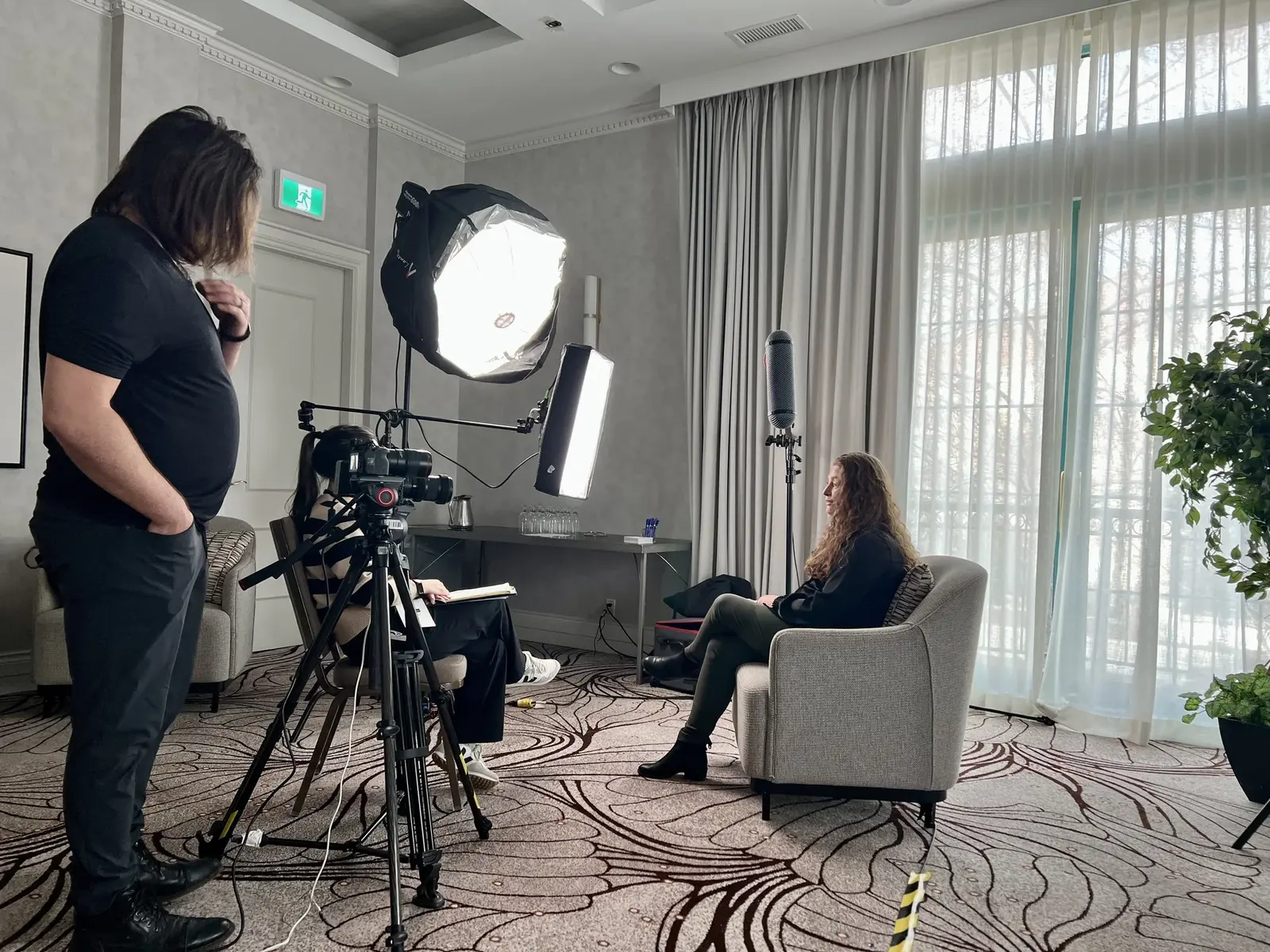 Camera, lights and boom microphone surround a seated SandBay interview subject.