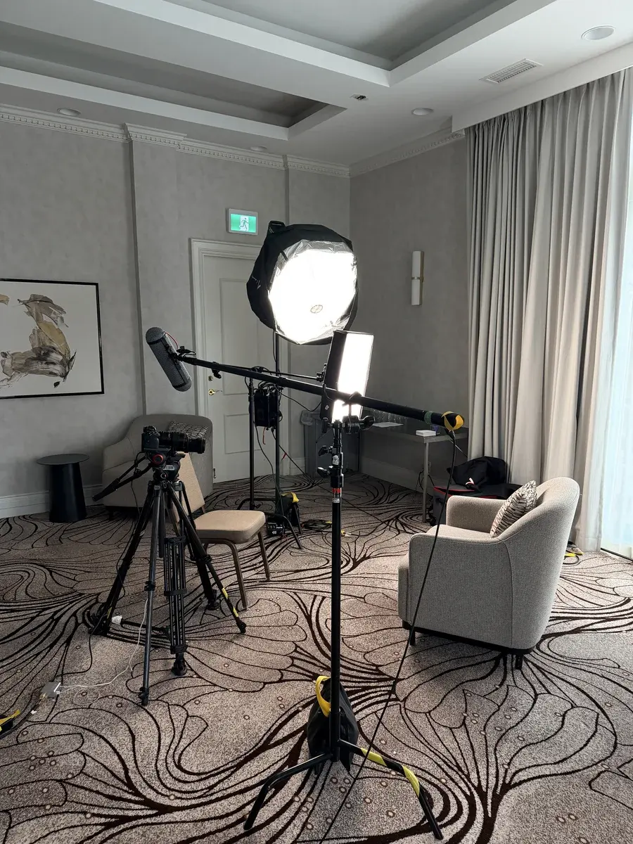 Camera, soft light, interview chair and boom mic prepared for SandBay Entertainment conference interviews.