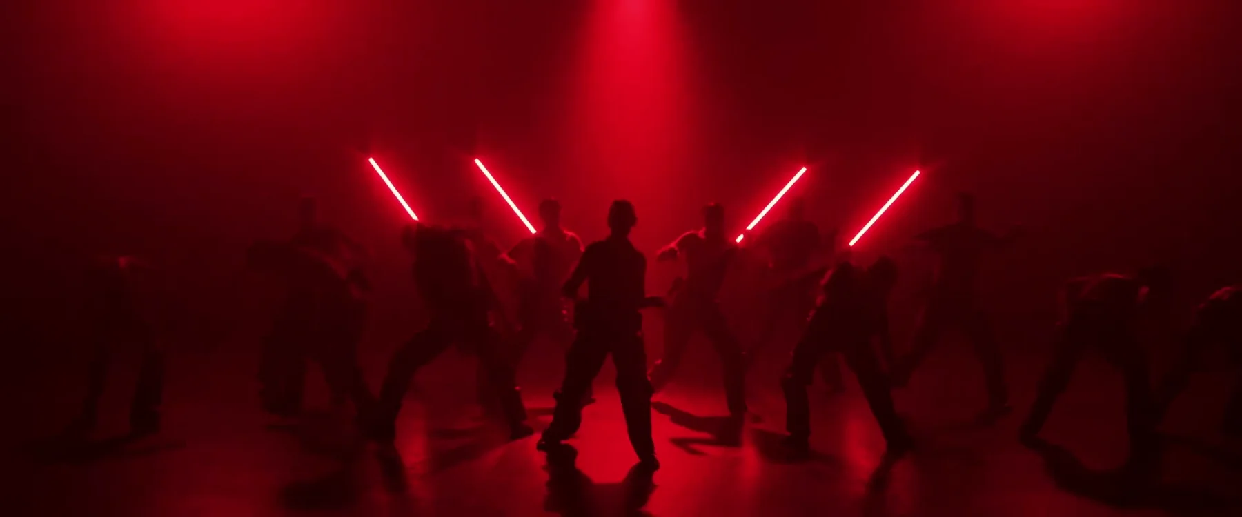 Sockeye 2024 ensemble spreads across the stage beneath red diagonal lights.