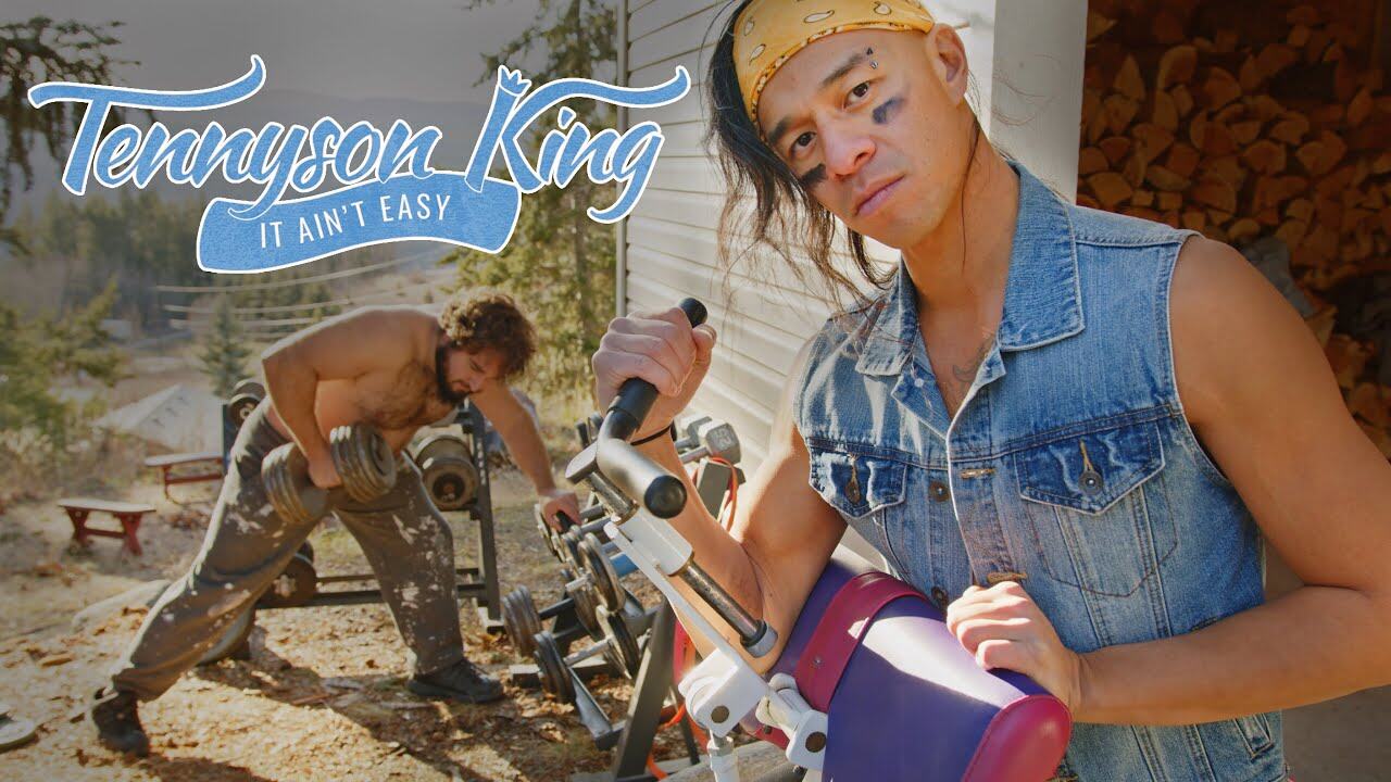 Musician Tennyson King performs among members of an arm-wrestling club.
