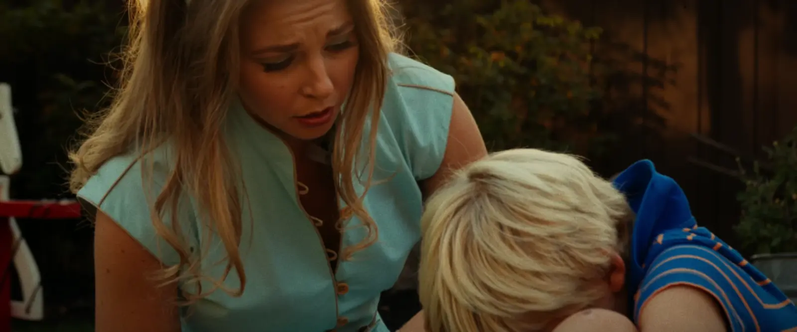 1960s Connie comforts young Dave in the yard in a finished frame from Three Hearts.