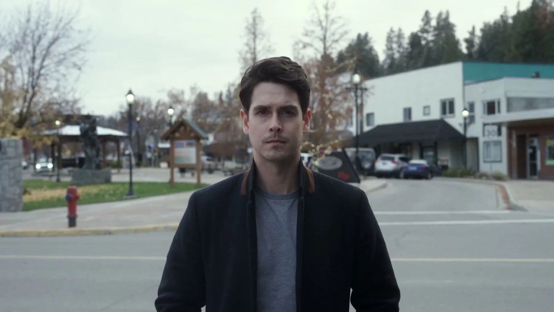 A man stands on a small-town street in Princeton, British Columbia.